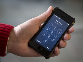 FILE - In this Feb. 17, 2016, file photo an iPhone is seen in Washington. The Supreme Court is hearing a case on Nov. 29, 2017, about privacy in the digital age that tests whether police generally need a warrant to review cellphone tower records. Police use the records to help place suspects in the vicinity of crimes. Rights groups across the political spectrum, media organizations and technology experts are among those arguing that it is too easy for authorities to learn revealing details of Americans' lives merely by examining the records kept by cellphone service companies. (AP Photo/Carolyn Kaster, File)