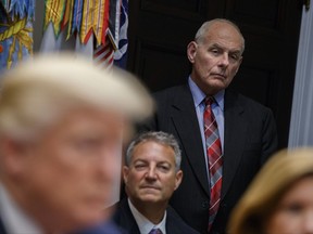 White House chief of staff John Kelly listens as President Donald Trump speaks during a meeting on tax policy with business leaders in the Roosevelt Room of the White House, Tuesday, Oct. 31, 2017, in Washington. In his three months on the job, Kelly has been credited with bringing order to a chaotic West Wing, but don't call him a moderate. President Donald Trump's chief of staff was the enforcer of Trump's controversial immigration policies, has frequently criticized the president's enemies, and this week echoed his boss' defense of Confederate monuments. (AP Photo/Evan Vucci)