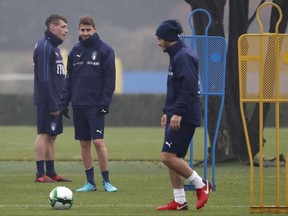 Italy's Jorginho, center, smiles with his teammates Alessandro Florenzi, right, and Andrea Belotti during a training session ahead of Monday's World Cup qualifying play-off return leg soccer match against Sweden, in Appiano Gentile, near Milan, Italy, Sunday, Nov. 12, 2017. (AP Photo/Antonio Calanni)
