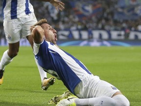 Porto's Hector Herrera, on the ground, celebrates after scoring the opening goal during the Champions League group G soccer match between FC Porto and RB Leipzig at the Dragao stadium in Porto, Portugal, Wednesday, Nov. 1, 2017. (AP Photo/Luis Vieira)