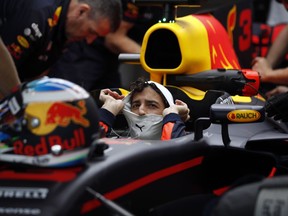Red Bull driver Daniel Ricciardo of Australia sits in his car in the team box during the third free practice at the Yas Marina racetrack in Abu Dhabi, United Arab Emirates, Saturday, Nov. 25, 2017. The Emirates Formula One Grand Prix will take place on Sunday. (AP Photo/Hassan Ammar)