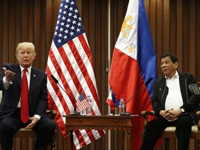 U.S. President Donald Trump, left, gestures beside Philippine President Rodrigo Duterte as they hold a bilateral meeting on the sidelines of the 31st Association of Southeast Asian Nations (ASEAN) Summit and Related Meetings at the Philippine International Convention Center in Manila, Philippines Monday Nov. 13, 2017. (Rolex dela Pena/Pool Photo via AP)