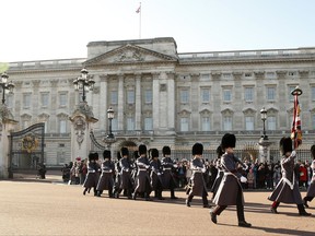 Members of the Coldstream Guards march out as the "New Guard" from Buckingham Palace towards St James's Palace, during a changing of the guard ceremony in London, Monday, Nov. 6, 2017. Newly leaked papers have revealed that Queen Elizabeth II has placed some of her private money into offshore tax havens. According to records obtained by the International Consortium of Journalists, the queen's investment managers have placed roughly 10 million pounds ($13 million) in offshore portfolios in the Cayman Islands and Bermuda. Buckingham Palace is the Queens official residence in London.(AP Photo/Alastair Grant)