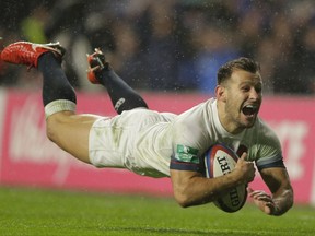 England's Danny Care smiles as he goes over the line for England's fourth try during their rugby union international match between England and Australia at Twickenham stadium in London, Saturday, Nov. 18, 2017. (AP Photo/Alastair Grant)