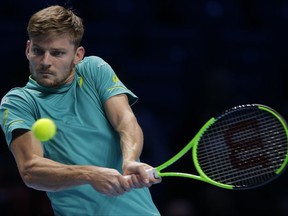 David Goffin of Belgium plays a return to Dominic Thiem of Austria during their men's singles tennis match at the ATP World Finals at the O2 Arena in London, Friday, Nov. 17, 2017. (AP Photo/Alastair Grant)