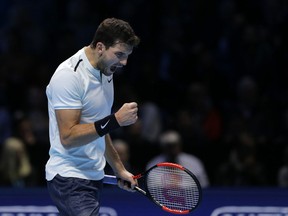 Grigor Dimitrov of Bulgaria celebrates after winning the first set against David Goffin of Belgium during the men's singles final of the ATP World Finals at the O2 Arena in London, Sunday, Nov. 19, 2017. (AP Photo/Alastair Grant)