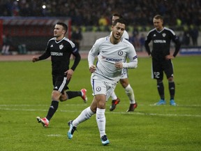 Chelsea's Eden Hazard celebrates after scoring the opening goal of the game from the penalty spot during their Champions League, group C, soccer match between Qarabag FK and Chelsea at the Baku Olympic stadium in Baku, Azerbaijan, Wednesday, Nov. 22, 2017. (AP Photo/Pavel Golovkin)