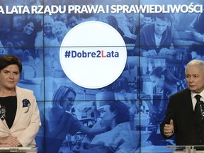 Leader of Poland's ruling party Law and Justice, Jaroslaw Kaczynski, right, and Polish Prime Minister Beata Szydlo attend a press conference summarizing two years of the party's government, in Warsaw, Poland, Tuesday, Nov. 14, 2017. The video wall behind reads: Two years of Law and Justice Government. Good 2 Years. (AP Photo/Alik Keplicz)