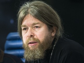 FILE In this file photo taken on Friday, Nov. 13, 2015, Russian Orthodox Church bishop Tikhon speaks at a news conference on the issue of the remains of Russia's last Czar in Moscow, Russia. Father Tikhon Shevkunov, the Russian Orthodox Church bishop is heading the church's panel investigating the circumstances of the 1918 killing of Russian last czar and his family. (AP Photo/Ivan Sekretarev, File)