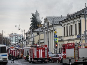 Firefighters attend the scene of a fire at the Private Collections of the Pushkin State Museum of Fine Arts in Moscow, Russia, Friday, Nov. 3, 2017. Emergency officials say that the fire hasn't hurt anyone and hasn't damaged any art works. (AP Photo/Alexander Zemlianichenko)