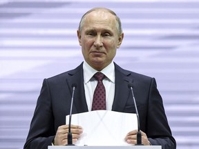 Russian President Vladimir Putin pauses as he speaks, at the 3rd Railway Congress in Moscow in Moscow, Russia, Wednesday, Nov. 29, 2017. Putin spoke to railway workers about the industry problems and voiced hoped that Russian Railways will work well to serve visitors of the World Cup in Russia next year. (Yuri Kadobnov/Pool Photo via AP)