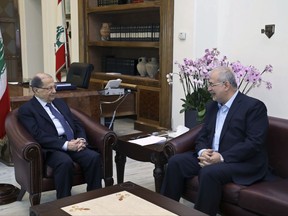 In this photo released by the Lebanese Government, Lebanese President Michel Aoun, left, meets with the head of Hezbollah's parliamentary bloc Mohammed Raad, at the Presidential Palace in Baabda, east of Beirut, Lebanon, Monday, Nov. 27, 2017. Aoun has begun two-day consultations with the country's political leaders over the government's future and Lebanon's commitment to keeping itself away from regional conflicts. (Dalati Nohra/Lebanese Government via AP)