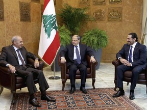 In this photo released by the Lebanese Government, Lebanese President Michel Aoun, center, meets with Prime Minister Saad Hariri, right, and Parliament Speaker Nabih Berri, left, at the Presidential Palace in Baabda, east of Beirut, Lebanon, Monday, Nov. 27, 2017. Aoun launched consultations with the country's political leaders over the government's future in the wake of Prime Minister Saad Hariri's suspended resignation. (Dalati Nohra/Lebanese Government via AP)