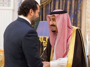 FILE -  In this Monday, Nov. 6, 2017 file photo, provided by the Saudi Press Agency, Saudi King Salman, right, shakes hands with outgoing Lebanese Prime Minister Saad Hariri in Riyadh, Saudi Arabia. The abrupt resignation of Hariri was bizarre even by the often twisted standards of Lebanese politics: Saad Hariri made the announcement from the Saudi capital in a pre-recorded message on a Saudi-owned station. (Saudi Press Agency, via AP, File)