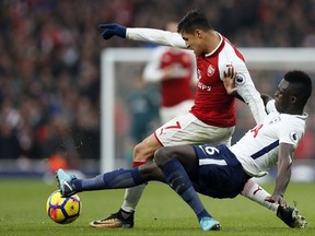 Arsenal's Alexis Sanchez, left, is challenged by Tottenham's Davinson Sanchez during the English Premier League soccer match between Arsenal and Tottenham Hotspur at Emirates stadium in London, Saturday, Nov. 18, 2017. (AP Photo/Kirsty Wigglesworth)