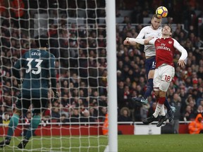 Tottenham's Eric Dier, center right, fails to score while airborne with Arsenal's Nacho Monreal during the English Premier League soccer match between Arsenal and Tottenham Hotspur at Emirates stadium in London, Saturday, Nov. 18, 2017. (AP Photo/Kirsty Wigglesworth)