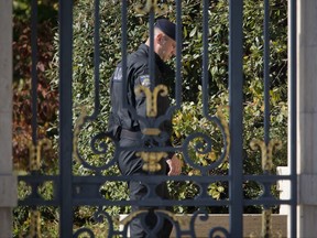 In tis Oct. 16, 2017 photo, a policeman stands at the entrance to the home of Ivica Todoric's family, a 16th century castle overlooking the Croatian capital, in Zagreb, Croatia. Croatia's most wanted fugitive Ivica Todoric surrendered to London police earlier this month amid accusations that he mismanaged his huge food and retail conglomerate and embezzled millions, leading to massive debt that is now an issue of concern for much of southeastern Europe. (AP Photo/Darko Bandic)