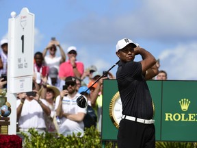 Tiger Woods tees off on the first hole at the Hero World Challenge golf tournament at Albany Golf Club in Nassau, Bahamas, Thursday, Nov. 30, 2017. (AP Photo/Dante Carrer)