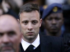 FILE -- In this Wednesday, June 15, 2016, file photo, Oscar Pistorius leaves the High Court in Pretoria, South Africa, after his sentencing proceedings. The Pistorius case is back in court, Friday, Nov. 3, 2017, with prosecutors seeking a longer jail sentence for the double-amputee athlete after he was found guilty of murder for shooting his girlfriend, Reeva Steenkamp. (AP Photo/Themba Hadebe, File)