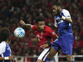 Japan's Urawa Reds' Rafael da Silva, in red, Al Hilal of Saudi ArabiaAl Hilal's Mohammed Jahfali, right, fight for the ball during the second leg of their AFC Champions League final soccer match in Saitama, north of Tokyo, Saturday, Nov. 25, 2017.(AP Photo/Koji Sasahara)