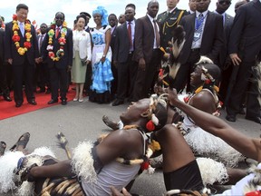 FILE - In this file photo taken on Dec. 1. 2015,  Chinese President Xi Jinping, left, and Zimbabwean President Robert Mugabe, second from right, next tot Chinese First lady Peng Liyuan and Zimbabwean First Lady Grace Mugabe watch a performance by Zimbabwean traditional dancers upon arrival in Harare, Zimbabwe. Under Mugabe's decades-long rule over Zimbabwe, China grew into one of its biggest investors, trading partners and diplomatic allies. Now, as the African nation appears on the verge of its first transition of power since independence, Beijing is poised to be among the biggest winners. (AP Photo/Tsvangirayi Mukwazhi, File)