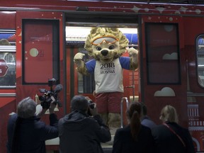 The mascot of the 2018 World Cup, the wolf named Zabivaka, peers out of the metro train branded for the 2018 World Cup during a ceremony in Moscow, Russia, on Tuesday, Nov. 28, 2017. (AP Photo/Ivan Sekretarev)