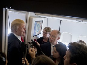 U.S. President Donald Trump speaks to reporters aboard Air Force One, Saturday, Nov. 11, 2017, while traveling to Hanoi, Vietnam. Trump is on a five country trip through Asia traveling to Japan, South Korea, China, Vietnam and the Philippines. (AP Photo/Andrew Harnik)