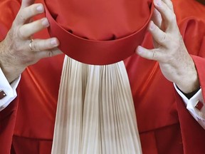 File - In this July 11, 2017 photo, judge  Ferdinand Kirchhof holds his hat at the Federal Constitutional Court in Karlsruhe, Germany. Germany's highest court has ruled that authorities must allow people to be entered in official records as something other than male or female. The Federal Constitutional Court published its ruling Wednesday Nov. 8, 2017 in the case of a person who had an application rejected to have their entry in the birth register changed from "female" to "inter/diverse" or "diverse."  (Uli Deck/dpa via AP,file)