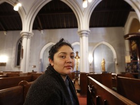 In this Oct. 26, 2017 photo, Amanda Morales, 33, poses for a photograph in the sanctuary of the Holyrood Episcopal Church, the Bronx borough of New York. Morales has been living in two small rooms of the gothic church at the northern edge of Manhattan since August, shortly after immigration authorities ordered her deported to her homeland of Guatemala. (AP Photo/Kathy Willens)