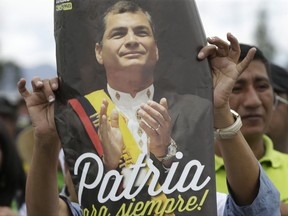 FILE - In this July 10, 2017 file photo, supporters of Ecuador's former President Rafael Correa gather to bid him farewell before he departs for Belgium to live with his family, from Quito, Ecuador. Correa announced he would return to Ecuador as early as Nov. 24, where his once powerful Alianza País government party is virtually divided between those who still support him and a majority who have aligned with the current president, Lenin Moreno. (AP Photo/Dolores Ochoa, File)