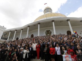 FILE - In this Aug. 4, 2017 file photo, Venezuela's Constitutional Assembly poses for an official photo after being sworn in, at the National Assembly in Caracas, Venezuela. The all-powerful assembly passed a wide-reaching law on Nov. 8 that clamps down on social media and broadcasters alike by ordering prison sentences of up to 20 years for anyone who instigates hate. (AP Photo/Ariana Cubillos, File)