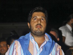 In this Sunday, Sept. 8, 2013 photo, Turkish-Iranian businessman Reza Zarrab, who is charged in the U.S. for evading sanctions on Iran, watches a concert in Istanbul. Turkish prosecutors on Saturday, Nov. 18, 2017, launched an investigation into two U.S. prosecutors involved in trying Zarrab, according to the country's official news agency. The case against gold trader Zarrab, 34, is built on work initially performed by Turkish investigators who targeted him in 2013 in a sweeping corruption scandal that led high up to Turkish government officials.(Depo Photos via AP)