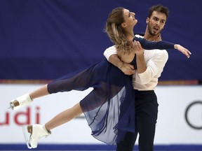 Gabriella Papadakis, left, and Guillaume Cizeron of France compete in the Ice Dance Free Dance during the Audi Cup of China ISU Grand Prix of Figure Skating 2017 at the Capital Gymnasium in Beijing, Saturday, Nov. 4, 2017. (AP Photo/Mark Schiefelbein)