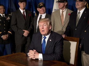 U.S. President Donald Trump speaks after signing a proclamation honoring veterans at the Hyatt Regency Danang Resort in Danang, Vietnam, Friday, Nov. 10, 2017. Trump is in Vietnam to attend the Asia-Pacific Economic Cooperation (APEC) Summit. (AP Photo/Mark Schiefelbein)