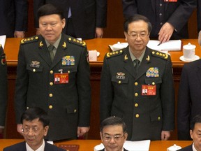 In this March 5, 2017, photo, Zhang Yang, left, the then-head of China's People's Liberation Army (PLA) political affairs department, and Fang Fenghui, right, the then-chief of the general staff of the Chinese People's Liberation Army stand during the opening session of China's National People's Congress (NPC) at the Great Hall of the People in Beijing, Sunday, March 5, 2017. Chinese state media said Tuesday, Nov. 28, 2017, that Zhang killed himself Nov. 23 at his home, to which he had been confined while under investigation for major corruption. (AP Photo/Mark Schiefelbein)