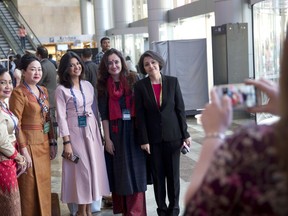 Delegates pose for a photo at the venue of the Global Entrepreneurship Summit in Hyderabad, India, Tuesday, Nov. 28, 2017. U.S. President Donald Trump's daughter, Ivanka Trump, is making a significant solo outing by headlining a business conference in India, but her trip highlights questions about whether her message of empowering poor women matches her actions. (AP Photo/Manish Swarup)