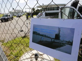 A picture of the Argentine submarine ARA San Juan written in Spanish "Come on steel men. We will wait for you at home" hangs from the fence at the Navel base in Mar del Plata, Argentina, Sunday, Nov. 19, 2017. Navy spokesman Enrique Balbi said Saturday the area being searched off the country's southern Atlantic coast has been doubled as concerns about the fate of the missing submarine and its crew grew. (AP Photo/Vicente Robles)