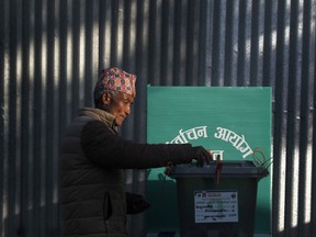 A Nepalese man casts his vote during the legislative elections in Chautara, Sindupalchowk, 80 kilometers (50 miles) east of Kathmandu, Nepal, Sunday, Nov. 26, 2017. People lined up to vote in the mountain villages and towns on the foothills of some of the highest mountains in world in Nepal's first provincial polls that promises to bring government closer to the rural and remote areas. (AP Photo/Niranjan Shrestha)