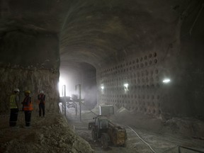 In this Tuesday, Nov. 14, 2017 photo, men work at the construction site of a massive underground cemetery in Jerusalem. Tunnels stretching more than a kilometer (half mile) in length have been carefully excavated over the past two years to make space for some 22,000 graves _ providing an innovative solution to meet the city's needs for the next decade.(AP Photo/Oded Balilty)