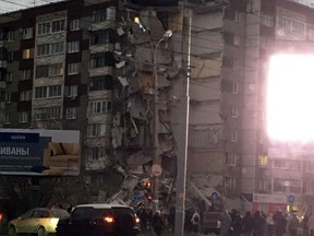 This photo provided by Alexander Cherezov shows as a section of a nine-story apartment building has collapsed in city of Izhevsk, Russia, Thursday, Nov. 9, 2017. At least two people have been pulled out of the rubble, according to Russian news reports. (Alexander Cherezov via AP)