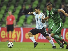 Argentina's Sergio Aguero, center, challenge for the ball with Nigeria's Leon Balogun, right, during the international friendly soccer match between Argentina and Nigeria in Krasnodar, Russia, Tuesday, Nov. 14, 2017. (AP Photo/Sergey Pivovarov)