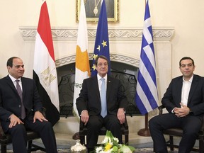 Cyprus President Nicos Anastasiades, center, Greek Prime minister Alexis Tsipras, right, and Egypt's President Abdel-Fattah el-Sissi talk during their meeting at the presidential palace on Tuesday, Nov. 21, 2017. The leaders of Cyprus, Egypt and Greece meet in the Cypriot capital for talks on forging closer ties and boosting cooperation on issues including energy following the discovery of gas deposits in the east Mediterranean. (Yiannis Kourtoglou/Pool Photo via AP)