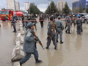 Afghan security personnel arrive to the site of a deadly suicide bombing, in Kabul, Afghanistan, Thursday, Nov. 16, 2017. An Afghan official said the suicide bomber killed nine people at a political gathering in the capital, Kabul. The Interior Ministry spokesman says the attacker detonated his payload at the entrance to a wedding hall where the event was being held, killing seven police and two civilians, and wounding others. (AP Photo/Rahmat Gul)