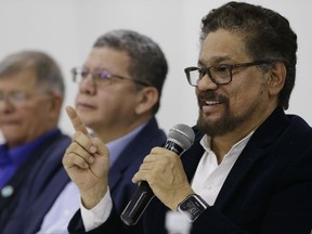 Ivan Marquez, a former leader of the Revolutionary Armed Forces of Colombia, FARC, announces that their one-time top commander, Rodrigo Londono, will run for president in next year's election during a press conference in Bogota, Colombia, Wednesday, Nov. 1, 2017. Marquez also announced the names of other nine former rebel leaders who, with him, will fill 10 seats in Congress guaranteed to the FARC political party on a temporary basis as part of last year's peace deal. (AP Photo/Ricardo Mazalan)