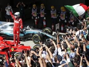 Ferrari driver Sebastian Vettel, of Germany, celebrates after winning the Brazilian Formula One Grand Prix at the Interlagos race track in Sao Paulo, Brazil, Sunday, Nov. 12, 2017. (AP Photo/Andre Penner)