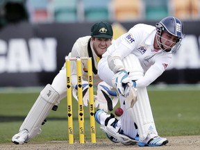 FILE - In this Nov. 9, 2013, file photo, England's Stuart Broad, right, sweeps the ball past Australia A's wicketkeeper Tim Paine during the final day of their cricket tour match in Hobart, Australia. After earning a recall for the start of the Ashes series, his first test in seven years, Paine is determined to put his long rehabilitation from injuries behind him and remain Australia's first-choice wicketkeeper. Paine was a shock selection for Australia in the first test against England. (AP Photo/Rick Rycroft, File)