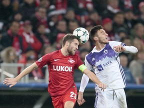 Spartak's Dimitry Kombarov, left, is airborne with Maribor's Gregor Bajde during the Champions League Group E soccer match between Spartak Moscow and Maribor in Moscow, Russia, Tuesday, Nov. 21, 2017. (AP Photo/Ivan Sekretarev)