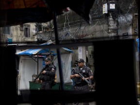 In this Oct. 23, 2017 photo, police patrol the Rocinha slum of Rio de Janeiro, Brazil. In October, police opened fire on the car that was carrying Spanish tourist Maria Esperanza Jimenez Ruiz and her relatives, killing Maria, as they left a walking tour of Rocinha, a favela at the center of a bloody battle between rival gangs and authorities. (AP Photo/Silvia Izquierdo)