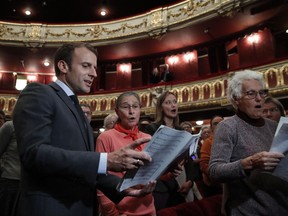 French President Emmanuel Macron sings as he attends a rehearsal of a non-professional chorus at Strasbourg's Opera house, eastern France, Tuesday, Oct. 31, 2017. (Christian Hartmann, Pool via AP)