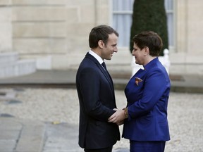 France's President Emmanuel Macron, left, welcomes Polish Prime Minister Beata Szydlo, prior to a meeting, at the Elysee Palace, in Paris, Thursday, Nov. 23, 2017. (AP Photo/Thibault Camus)